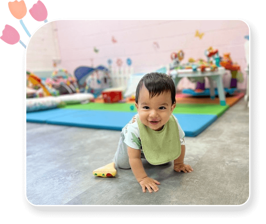 A baby is sitting on the floor in front of a room.
