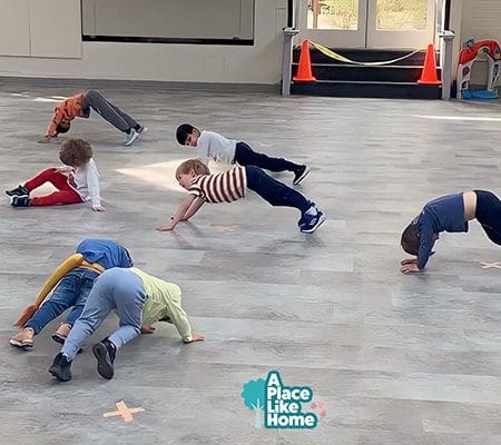 A group of kids doing different moves on the floor.