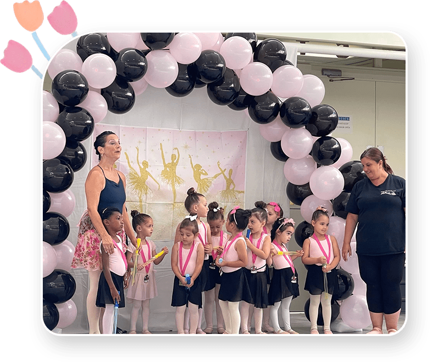 A group of girls standing in front of balloons.